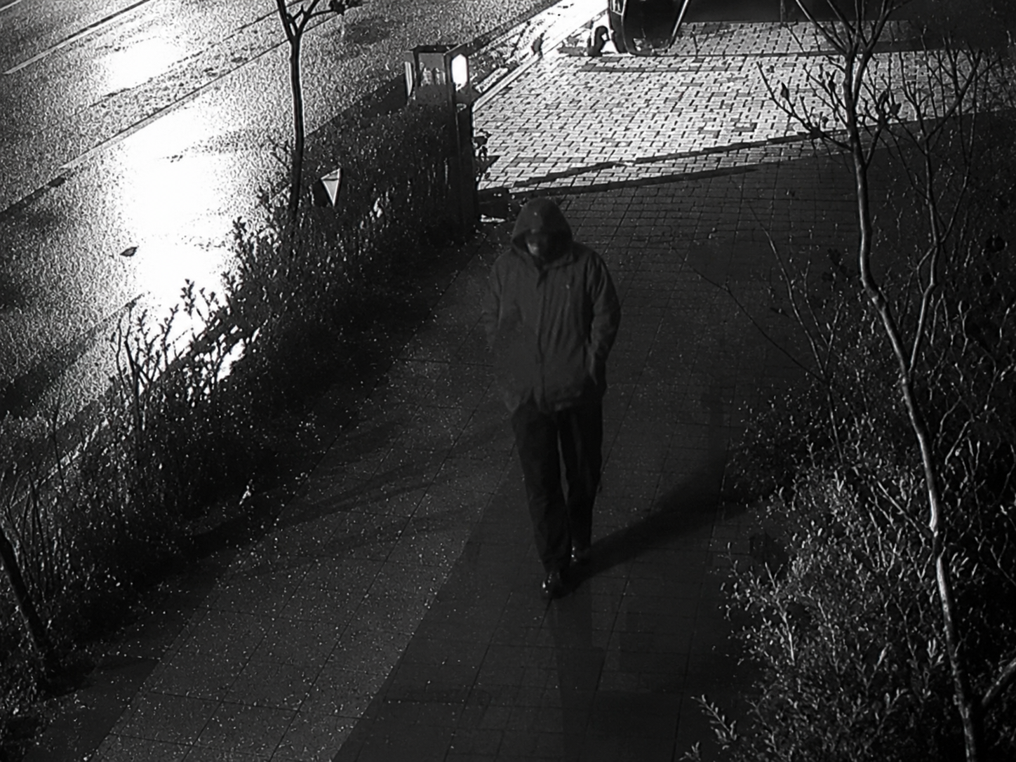Security camera footage of a street intersection at night