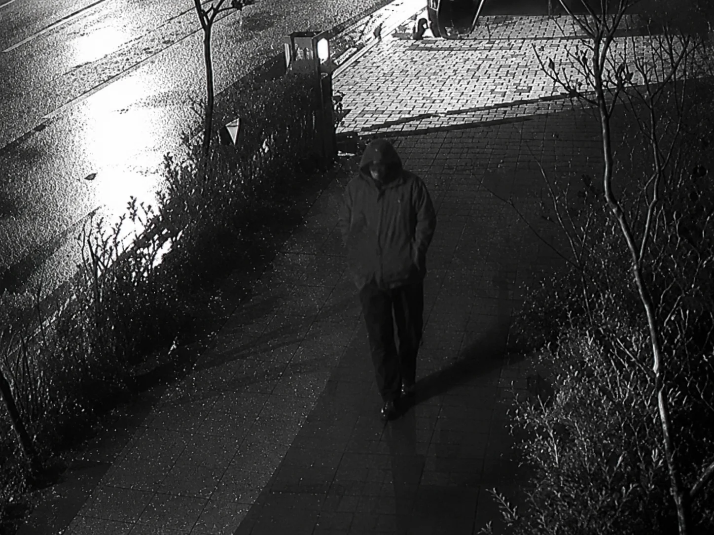Security camera footage of a street intersection at night