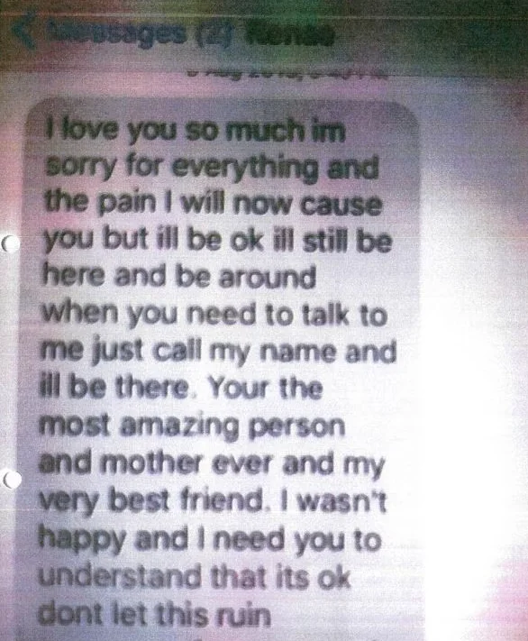 A phone screen showing a long goodbye text message that begins I love you so much im sorry for everything