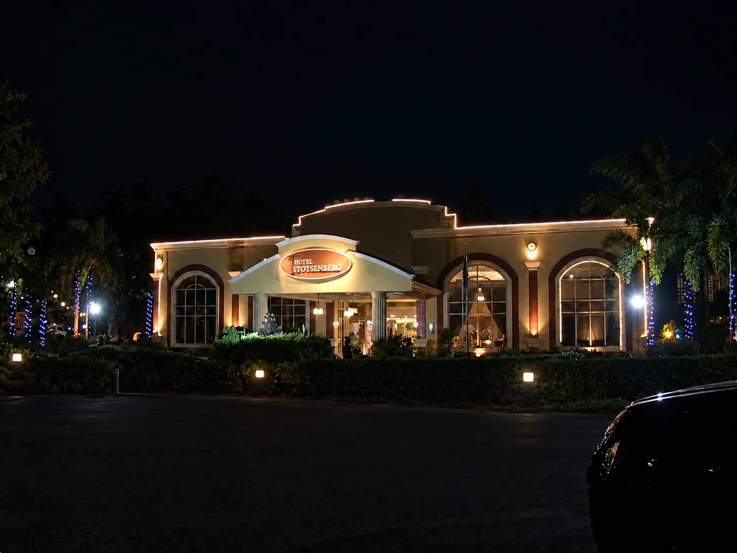 The illuminated entrance of Hotel Stotsenberg in Clark, Philippines, at night