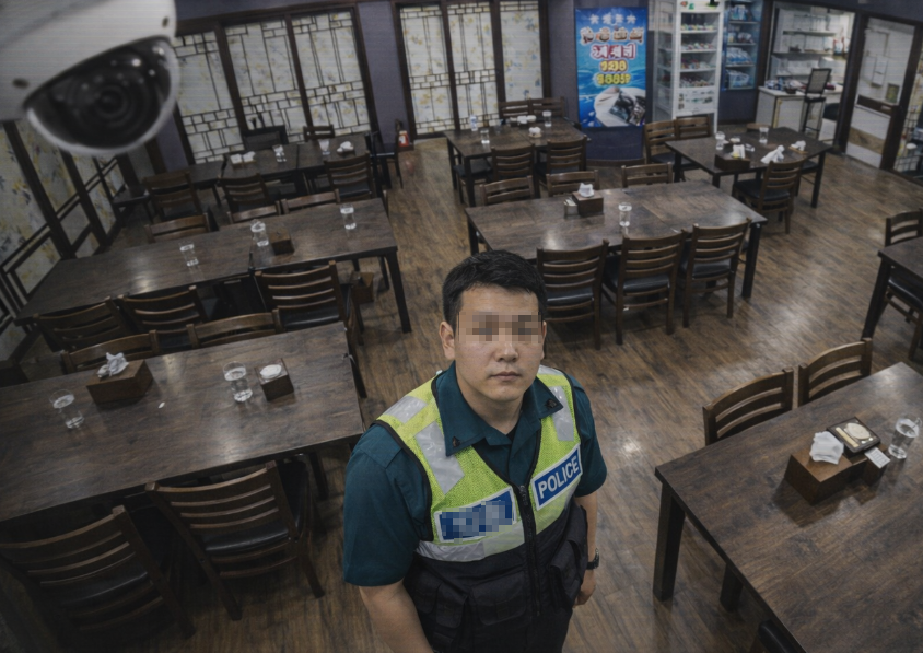 Police reviewing security camera footage inside restaurant